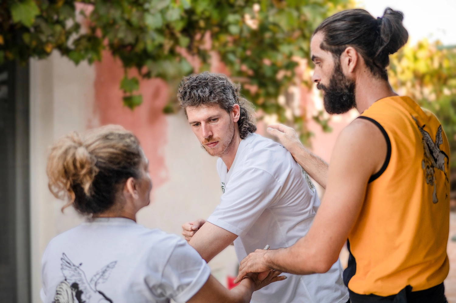 Thomas guiding a student closely during practice