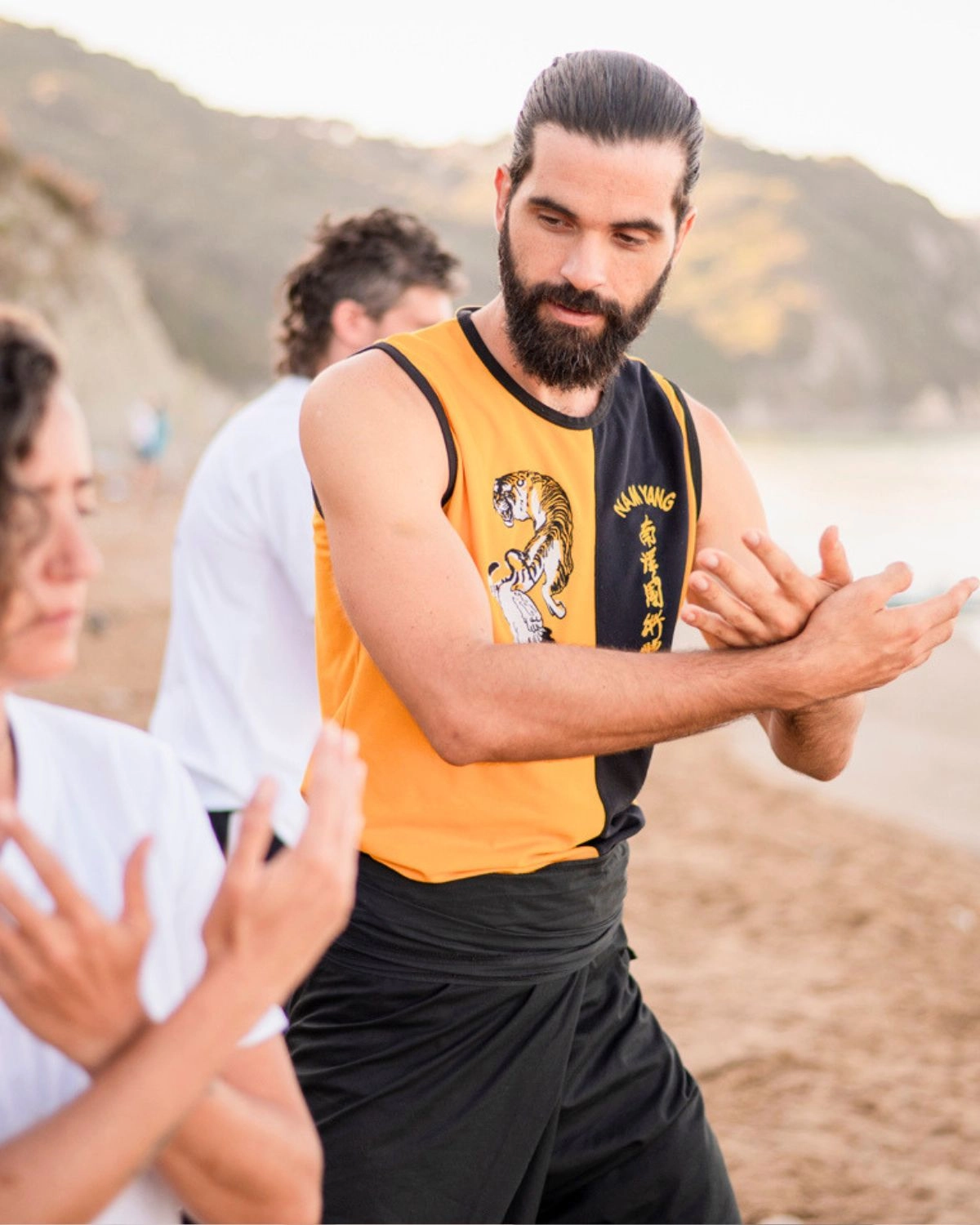 Thomas guiding a student during practice on the beach